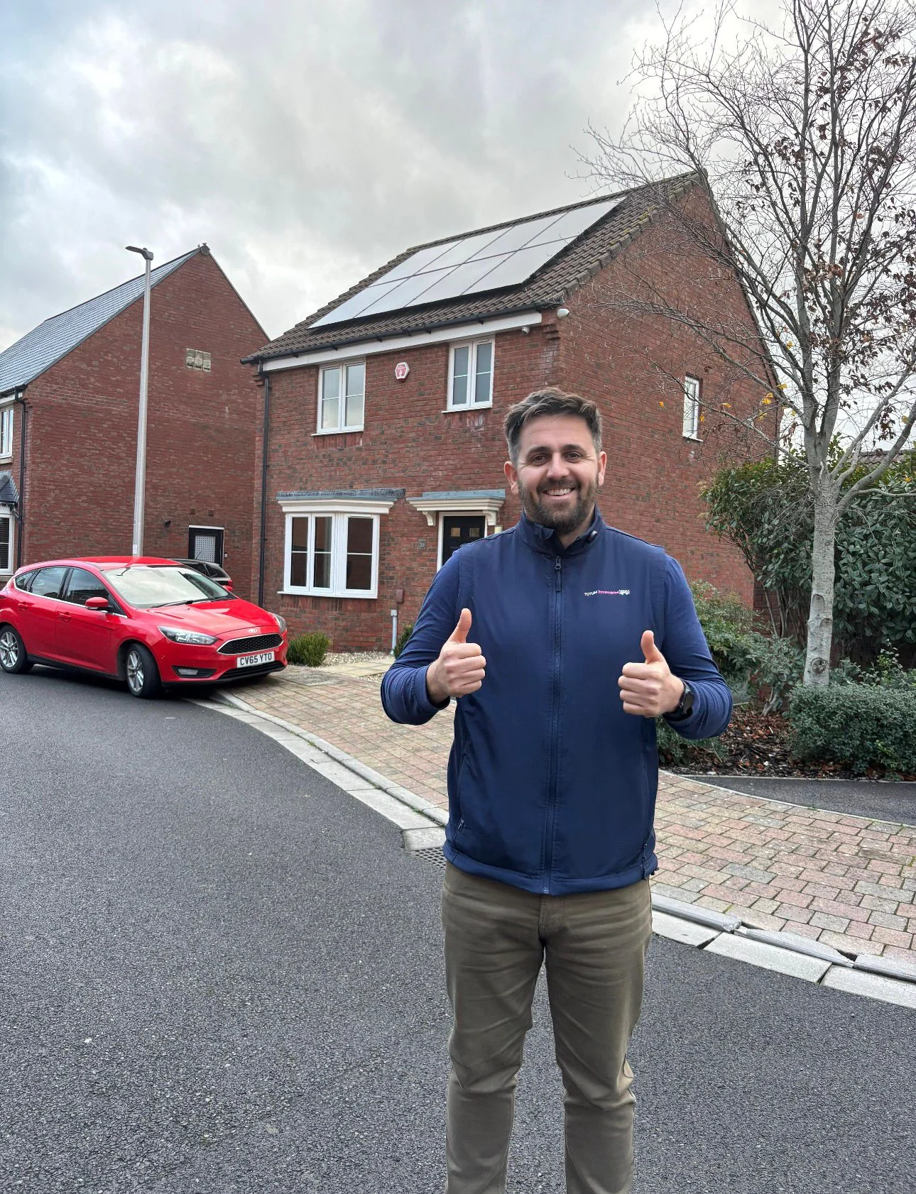 Chris Williams of Totum Renewables in front of a completed residential solar install in Somerset