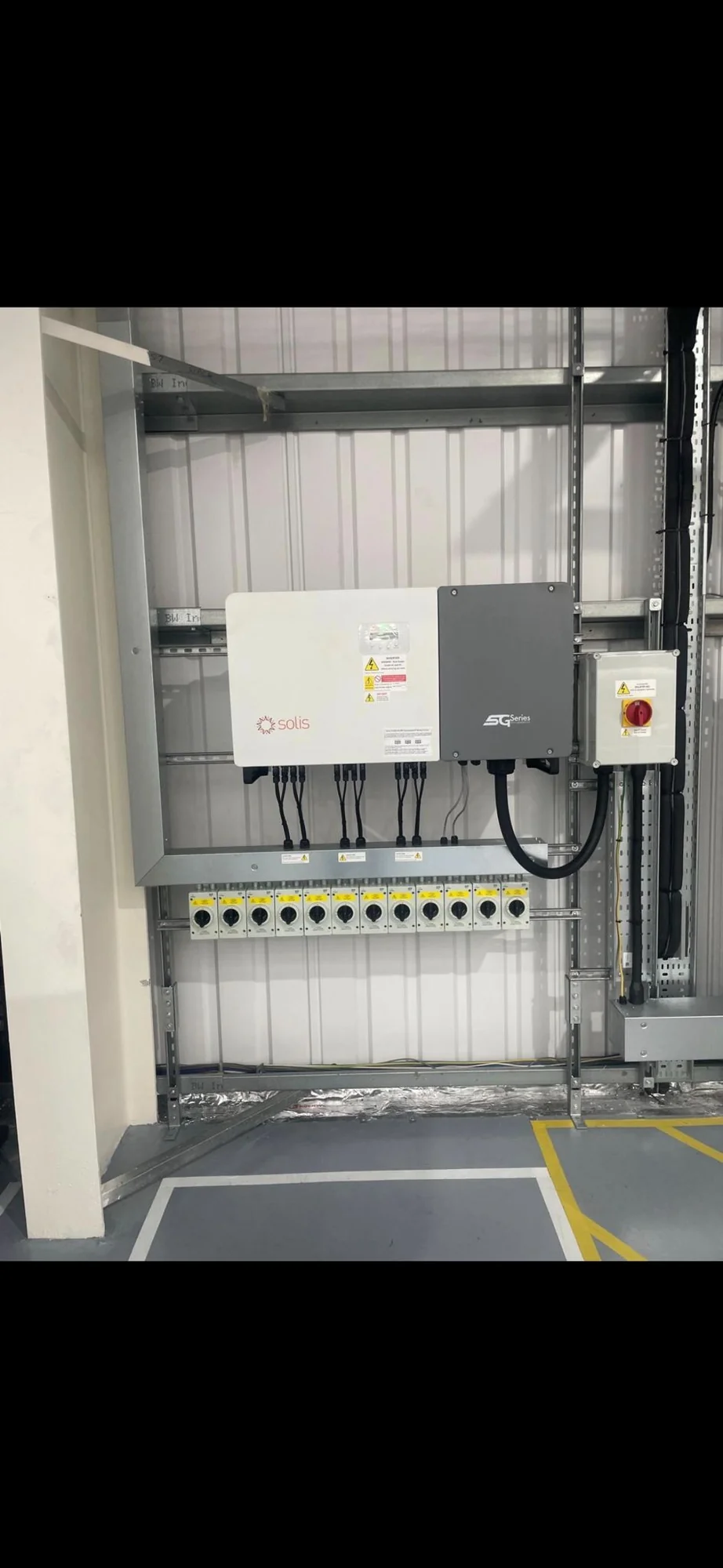 Inverter and isolators mounted on a garage wall
