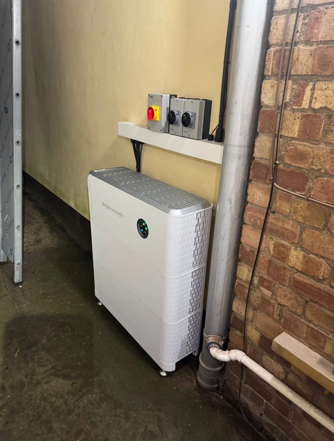 White home battery cabinet installed in a garage