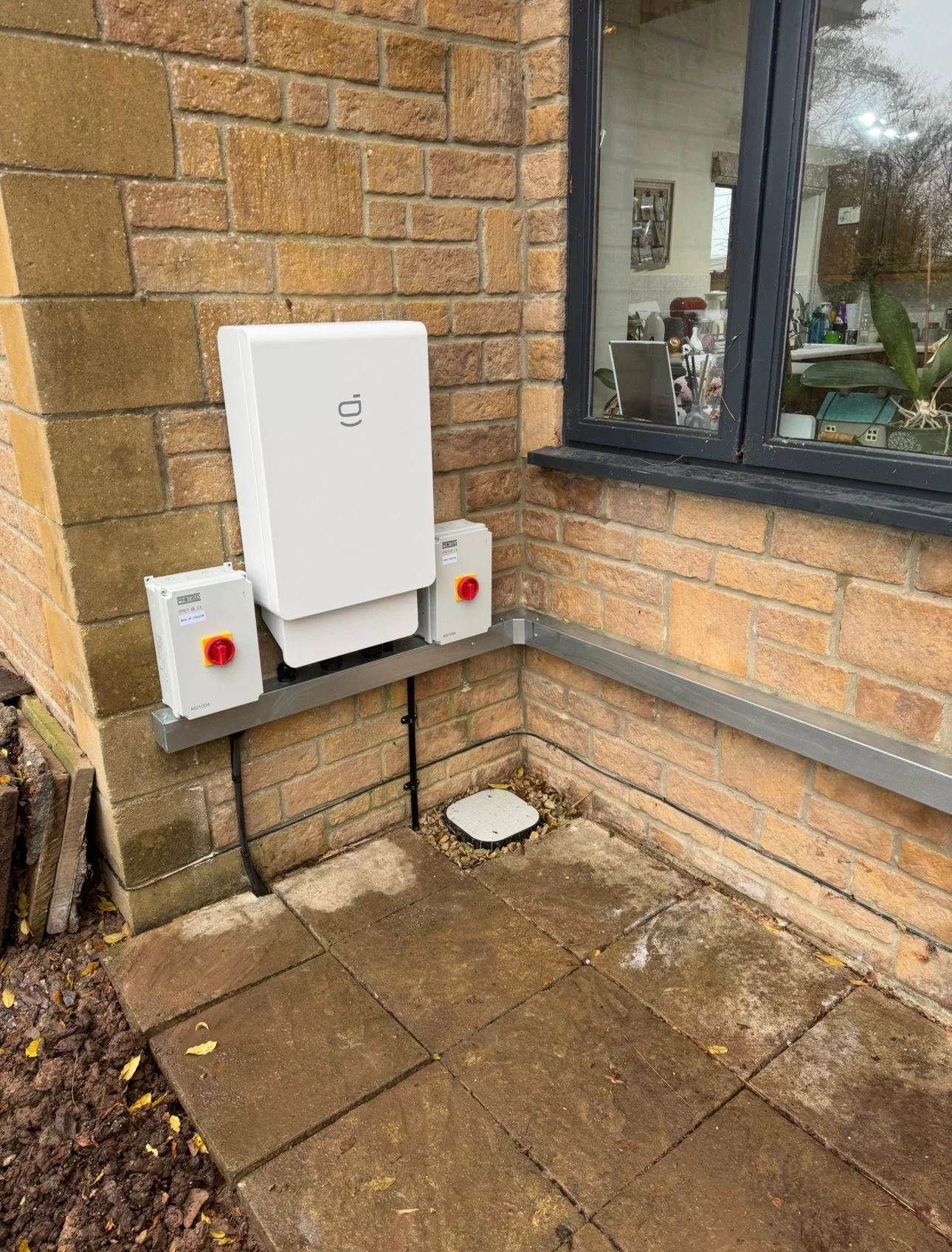 Outdoor home battery mounted on a house wall