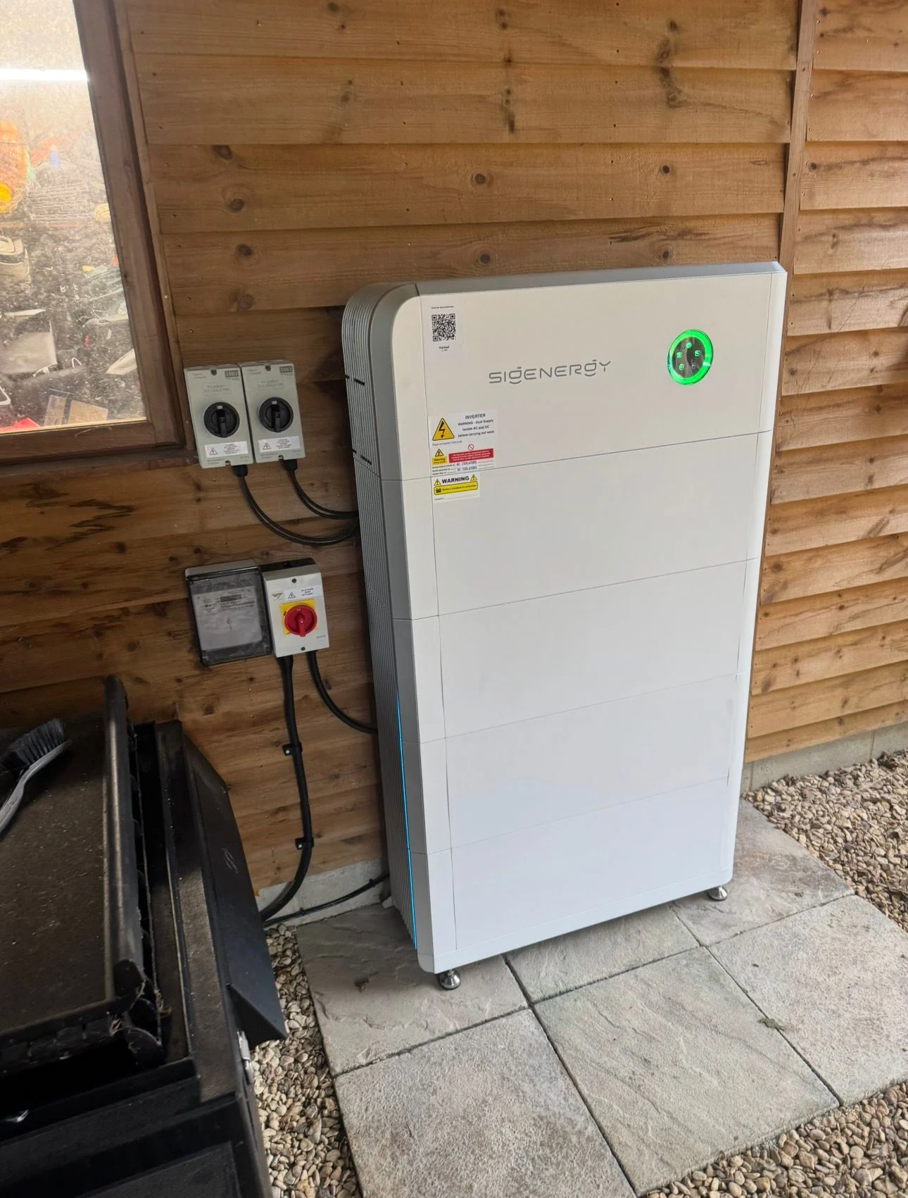 Outdoor Sigenergy battery against timber cladding