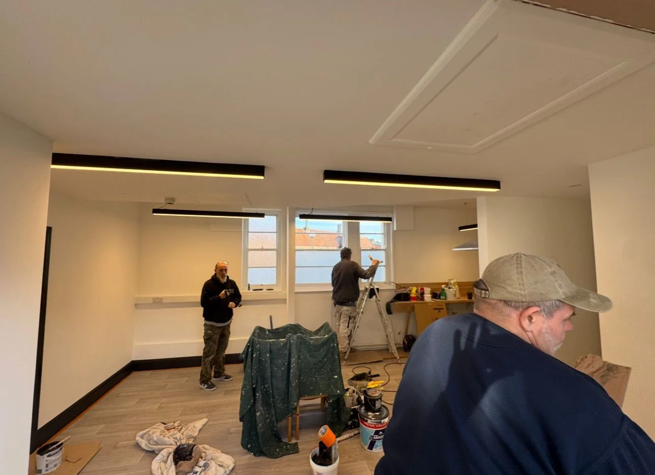 Office interior with linear LED ceiling lighting being installed