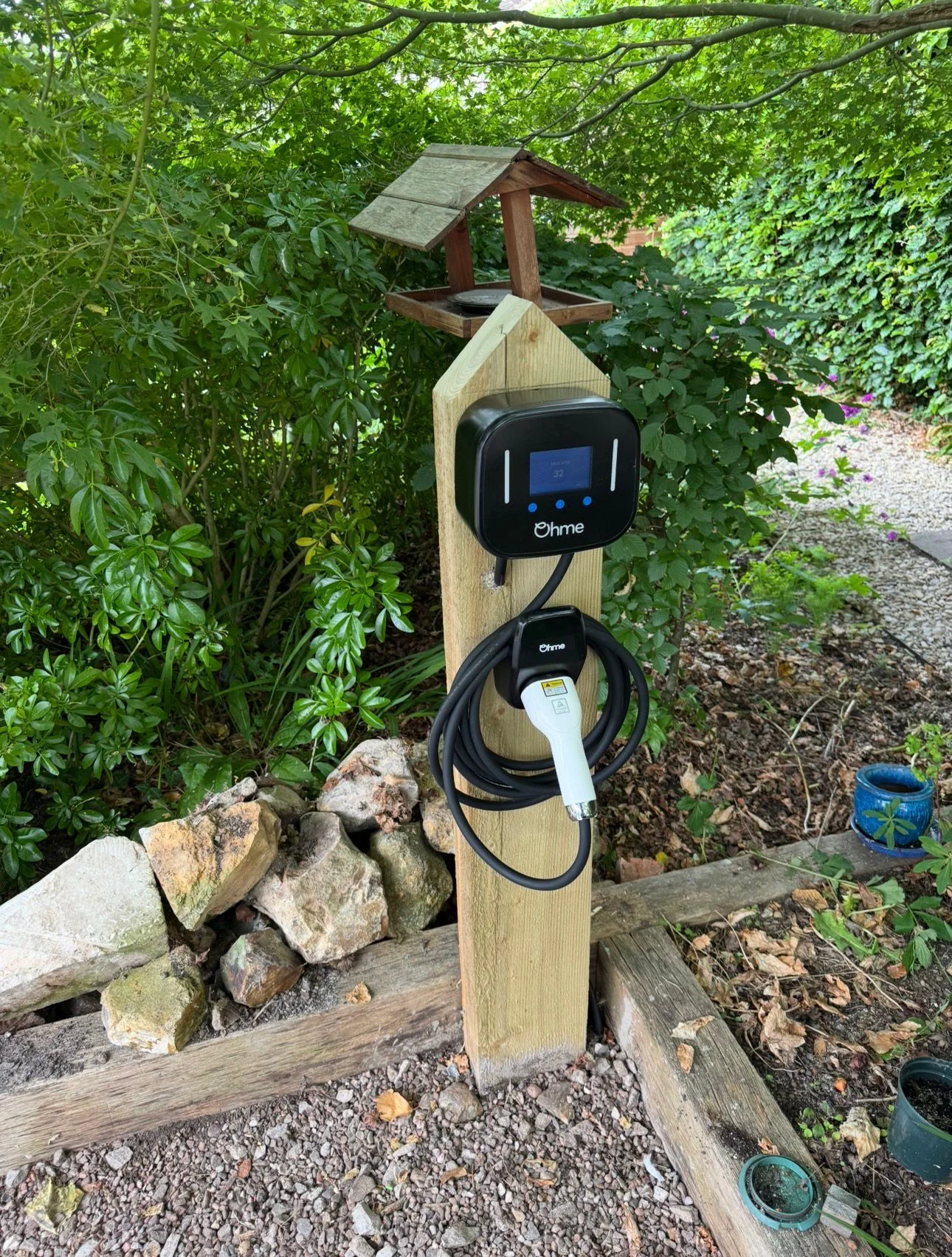 Ohme EV charger mounted on a residential side wall