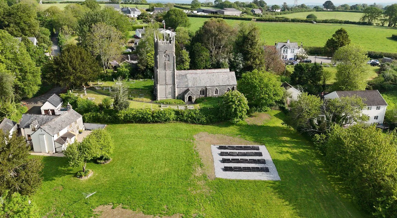Aerial view of a landscaped garden with a ground-mounted solar array