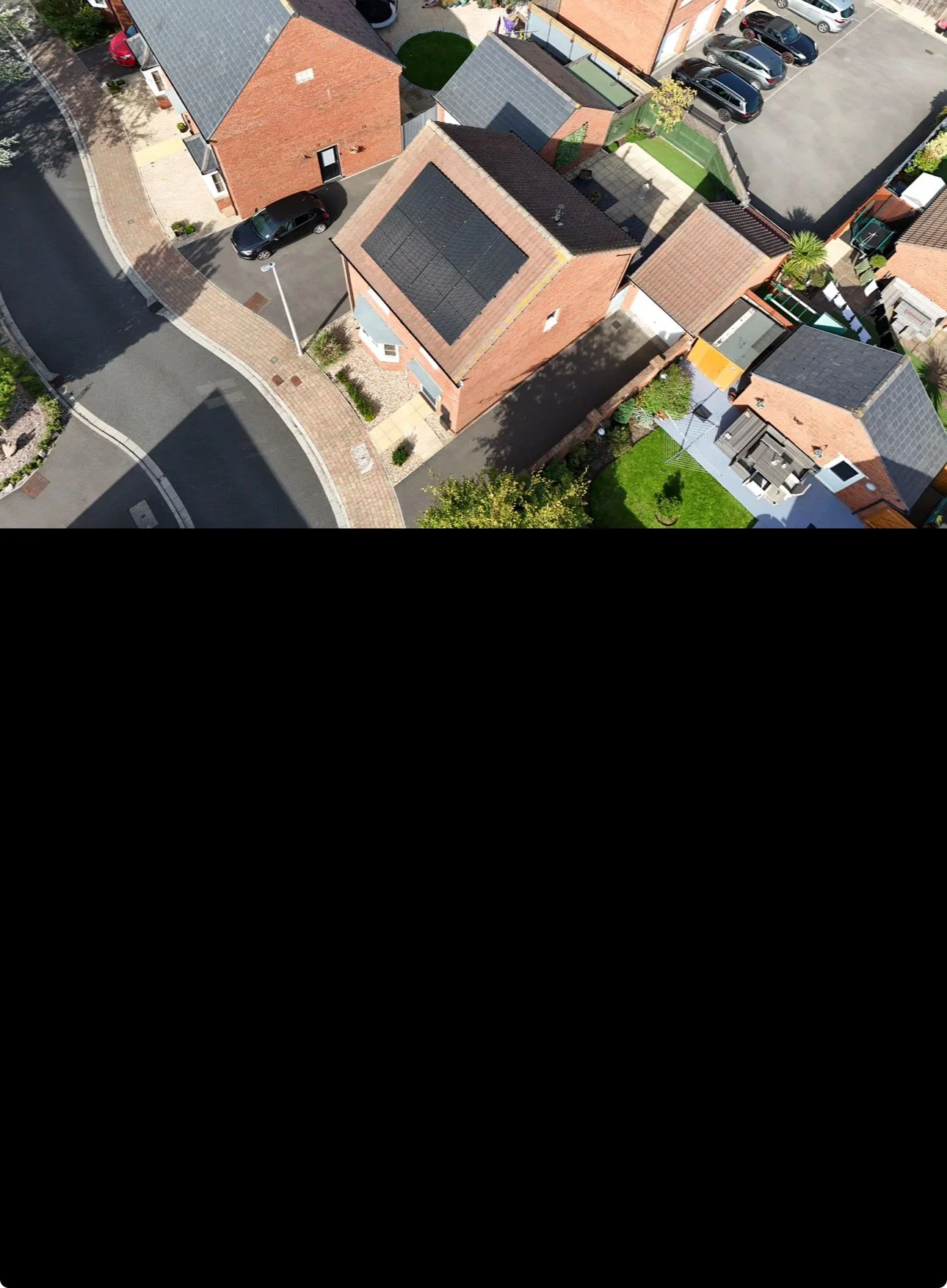 Aerial view of a housing estate with rooftop solar panels